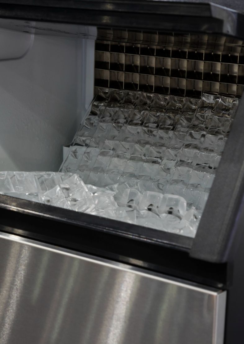 Freestanding commercial ice machine in a professional restaurant kitchen environment